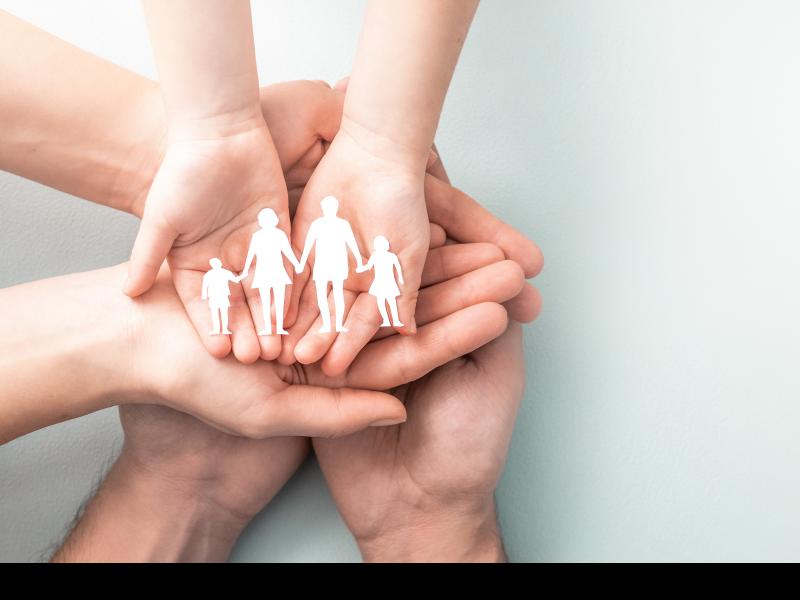 hands holding a paper family