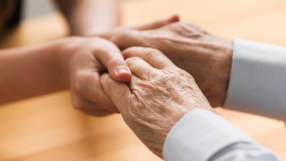 carer holding an older person's hands