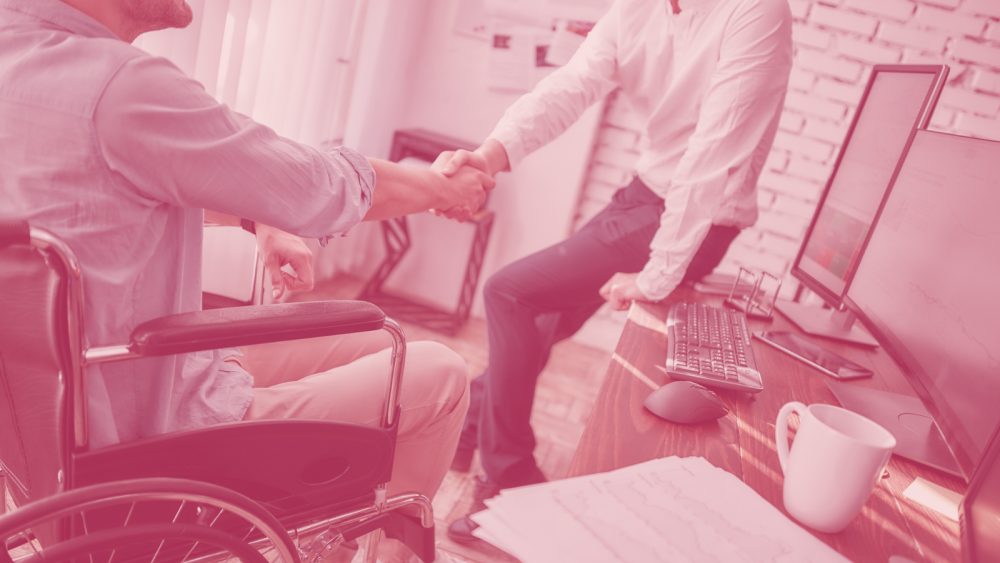 Handshake with person in wheelchair in office