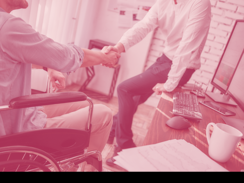 Handshake with person in wheelchair in office