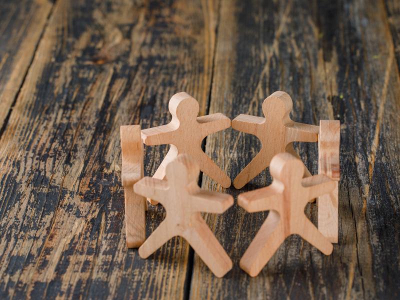 wooden figures on wooden worktop